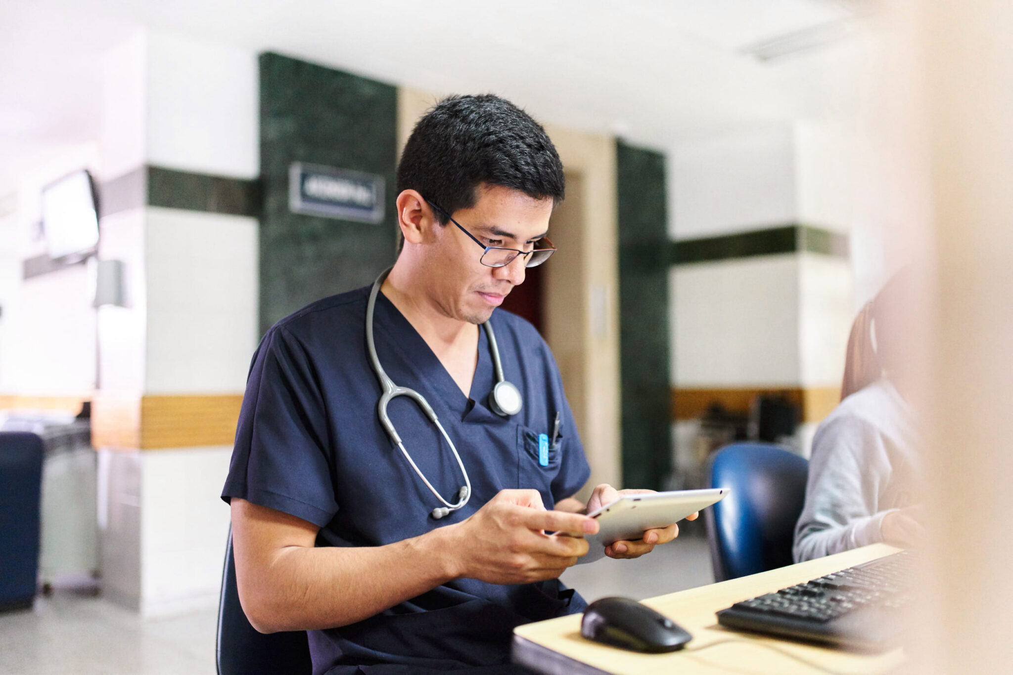 Clinician using a tablet in a dialysis clinic setting